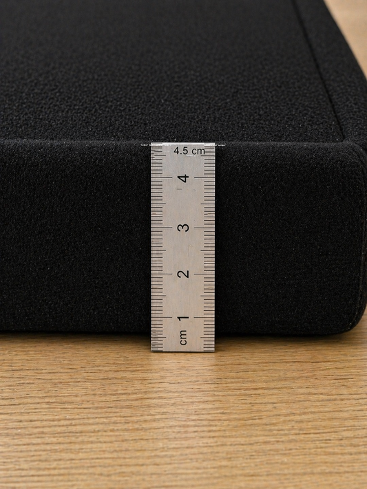 4.5cm thick black memory foam mat with ruler showing thickness